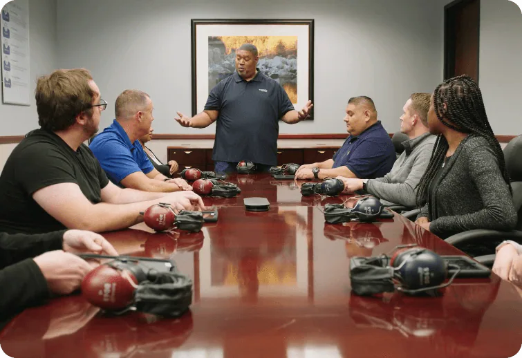 Employees in a meeting room at their facility
